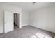 A bright, empty bedroom features neutral walls, gray carpet, white trim, and an open doorway at 400 W Rosemary St # 114, Chapel Hill, NC 27516