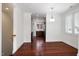 Dining area with hardwood floors and view into kitchen featuring stainless appliances at 400 W Rosemary St # 114, Chapel Hill, NC 27516