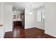 Bright dining area with hardwood floors and view into kitchen with stainless appliances at 400 W Rosemary St # 114, Chapel Hill, NC 27516