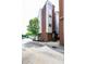 Exterior of a red brick building with white siding, showcasing modern architecture and a corner lot at 400 W Rosemary St # 114, Chapel Hill, NC 27516