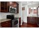 Kitchen with stainless steel appliances, granite countertops, cherry wood cabinets, and natural light at 400 W Rosemary St # 114, Chapel Hill, NC 27516