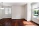 Living space with hardwood flooring, white walls, and two windows offering natural light at 400 W Rosemary St # 114, Chapel Hill, NC 27516