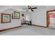 The finished attic includes carpet, painted trim, and multiple windows for natural light and ventilation at 407 Hillcrest Ave, Burlington, NC 27215