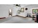 The finished attic has neutral carpeting, trim, and multiple windows for natural light and fresh air at 407 Hillcrest Ave, Burlington, NC 27215