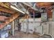 Unfinished basement showing the brick foundation and exposed ductwork and pipes at 407 Hillcrest Ave, Burlington, NC 27215