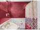 Colorful bathroom featuring sink, toilet, and shower/tub with patterned shower curtain at 407 Hillcrest Ave, Burlington, NC 27215