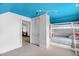 Bedroom with a blue ceiling featuring a bunk bed, storage space, and access to the living area at 407 Hillcrest Ave, Burlington, NC 27215
