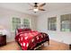 Cozy bedroom with hardwood floors, ceiling fan, and an abundance of natural light at 407 Hillcrest Ave, Burlington, NC 27215