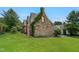 Charming stone and brick home with a well-manicured lawn and established landscaping at 407 Hillcrest Ave, Burlington, NC 27215