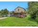 Home's backyard featuring expansive screened porch and healthy green grass and landscaping at 407 Hillcrest Ave, Burlington, NC 27215