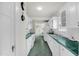 Galley kitchen with white cabinets, green countertops and flooring, and white appliances at 407 Hillcrest Ave, Burlington, NC 27215