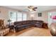 Inviting living room with hardwood floors, a ceiling fan, and a comfortable leather sectional sofa at 407 Hillcrest Ave, Burlington, NC 27215