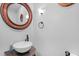 Charming powder room with a vessel sink, ornate mirror, granite countertop and modern fixtures at 407 Hillcrest Ave, Burlington, NC 27215