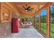 Cozy sunroom featuring a porch swing, string lights, and large windows with views of the backyard at 407 Hillcrest Ave, Burlington, NC 27215