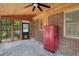 Bright sunroom with a porch swing, retro refrigerator, and views of the backyard through large windows at 407 Hillcrest Ave, Burlington, NC 27215
