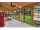 Sunroom with wood ceiling, cozy swing, retro fridge, and large windows overlooking the yard at 407 Hillcrest Ave, Burlington, NC 27215