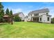 Spacious backyard featuring manicured lawn, playset, and a patio with outdoor seating at 4729 Adler Pass, Raleigh, NC 27612