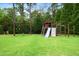 Backyard playset with a climbing structure, slide, and swings for outdoor fun at 4729 Adler Pass, Raleigh, NC 27612