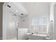 Elegant bathroom with a soaking tub, marble shower, and natural light at 4729 Adler Pass, Raleigh, NC 27612