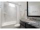 Well-lit bathroom showcasing a tub-shower combination and granite vanity at 4729 Adler Pass, Raleigh, NC 27612