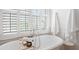 Bright bathroom featuring a soaking tub, white shutters, and stylish fixtures at 4729 Adler Pass, Raleigh, NC 27612