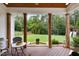 Covered patio with wood decking, and backyard view including a fountain and playset at 4729 Adler Pass, Raleigh, NC 27612