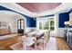 Elegant dining room featuring blue walls, a rustic table with seating for eight, and stylish chandelier at 4729 Adler Pass, Raleigh, NC 27612