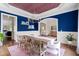 Elegant dining room featuring blue walls, a rustic table with seating for eight, and stylish chandelier at 4729 Adler Pass, Raleigh, NC 27612