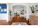 Inviting foyer with hardwood floors, plants, and stylish decor seamlessly blending into a bright, open-concept living space at 4729 Adler Pass, Raleigh, NC 27612