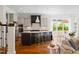 The open kitchen includes an island with seating, stainless steel appliances and flows into the breakfast and living areas at 4729 Adler Pass, Raleigh, NC 27612