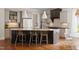 An open kitchen features a spacious island, stainless steel appliances, and a breakfast area with lots of natural light at 4729 Adler Pass, Raleigh, NC 27612