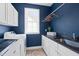 Well-organized laundry room featuring a sink and front load washer and dryer at 4729 Adler Pass, Raleigh, NC 27612