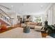 Bright and airy open concept living area featuring a modern kitchen, living room and adjacent staircase at 4729 Adler Pass, Raleigh, NC 27612