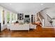Spacious open living room with a fireplace, large windows, and staircase at 4729 Adler Pass, Raleigh, NC 27612