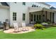 Charming patio with stone flooring, rocking chairs, a grill and manicured landscaping at 4729 Adler Pass, Raleigh, NC 27612