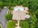 Stunning aerial view of the community pool, surrounded by lush trees and ample parking at 4729 Adler Pass, Raleigh, NC 27612
