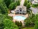 Aerial view of community pool with lounge chairs, a clubhouse and surrounding green space at 4729 Adler Pass, Raleigh, NC 27612