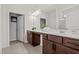 Bathroom with a double sink vanity, framed mirrors, and warm-toned cabinetry at 5081 Pioneer Dr, Sanford, NC 27330