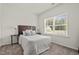 Inviting bedroom with plush carpet, a large window and contemporary decor at 5081 Pioneer Dr, Sanford, NC 27330