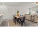 Dining area showcasing a rustic wooden table with seating for six, adjacent to the living room space at 5081 Pioneer Dr, Sanford, NC 27330