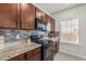 Close up of the Kitchen with sleek black appliances, granite countertops and modern cabinetry at 5081 Pioneer Dr, Sanford, NC 27330