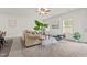 Bright and airy living room featuring neutral decor, a comfortable sofa, and large windows for natural light at 5081 Pioneer Dr, Sanford, NC 27330