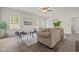 Cozy living room with a comfortable sofa, modern chairs, and a view of the well-lit interior at 5081 Pioneer Dr, Sanford, NC 27330