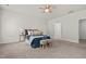 Bright main bedroom with a ceiling fan, plush carpeting and ensuite bathroom access at 5081 Pioneer Dr, Sanford, NC 27330