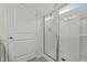 Bathroom featuring a glass enclosed shower and white painted door at 5081 Pioneer Dr, Sanford, NC 27330