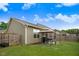 A well maintained fenced backyard with green grass, a small patio, and canopy offers plenty of space for outdoor activities at 51 Balboa Pkwy, Clayton, NC 27520