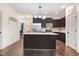 Modern kitchen with stainless steel appliances, granite countertops, and dark wood cabinets at 51 Balboa Pkwy, Clayton, NC 27520