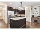 Well-lit kitchen featuring stainless steel appliances, dark cabinets, and granite countertops at 51 Balboa Pkwy, Clayton, NC 27520
