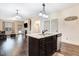 Open concept kitchen with granite counters, stainless appliances, and hardwood floors throughout the living area at 51 Balboa Pkwy, Clayton, NC 27520