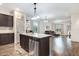 Open kitchen with granite counters and a view of the living room featuring hardwood floors throughout the home at 51 Balboa Pkwy, Clayton, NC 27520